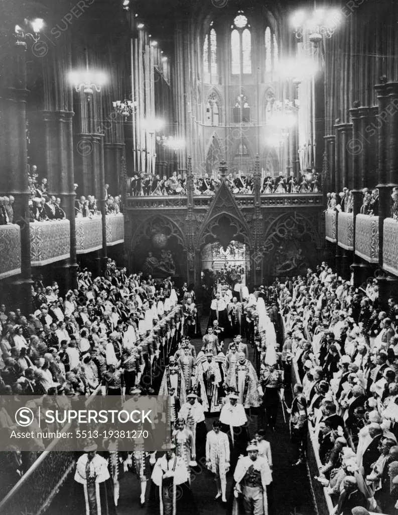 The Coronation Ceremony -- The King photographed wearing his crown and carrying the Orb and Sceptre photographed walking down the Abbey in procession after the crowing. May 12, 1937. (Photo by Keystone)