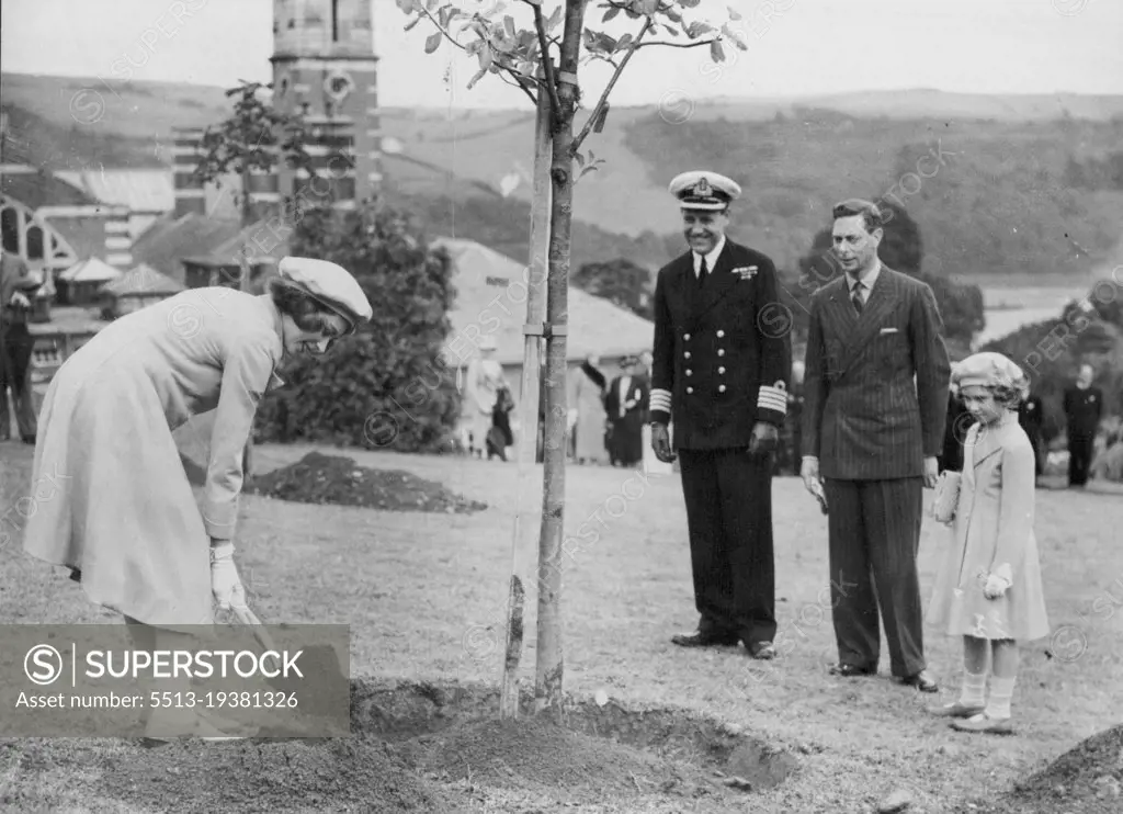 Royal Visit To Dartmouth -- Princess Elizabeth planting her tree in the College grounds, watched by the King and Princess Margaret Rose, at Dartmouth yesterday.The King and Queen and the Princess each planted a tree in the college grounds, during their visit to the Royal Naval College at Dartmouth yesterday. July 23, 1939. (Photo by Keystone).