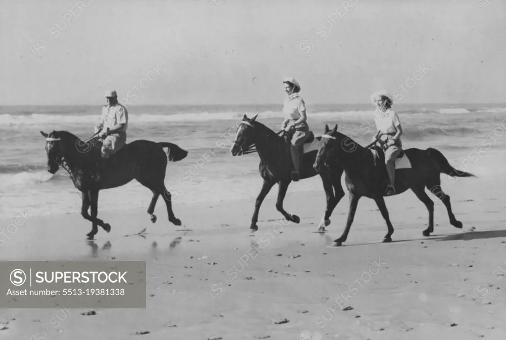 Princesses Ride On African Beach -- The Princess enjoyed an off-duty break from the Royal Tour of South Africa when they went riding on the golden sands of Bonza Beach, East London, Princess Elizabeth (centre) is riding Miss Yvonne Hayhoe's "Jill" while Princess Margaret rides "Treasure" owned by Mr. Pat O'Reilly. Mr. O'Reilly of East London, is seen escorting the Princesses. March 12, 1947.