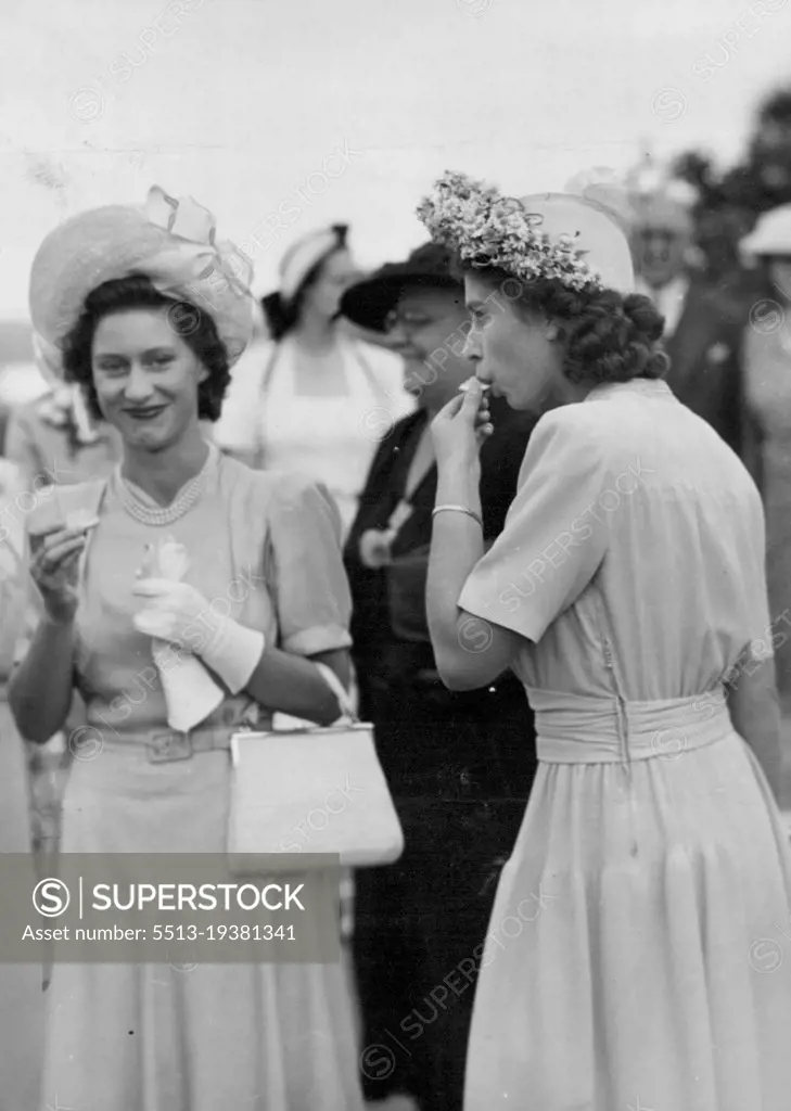 Princesses Share The King's Orange -- A delightfully informal picture of the Princesses both obviously enjoying the orange picked by the King. During the Royal Tour of South Africa, the King visited the Fruit Research Station at Nelspruit in the Pransvaal, where he picked an orange which he shared with the Princesses. April 08, 1947. April 08, 1947.