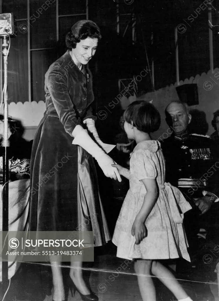 A Purse For the Princess - Six-year-old Wendy Aston shakes hands with Princess Alexandra after presenting her with a purse containing a contribution to the Benevolent and Orphan Fund of the National Union of Teachers, at Scarborough yesterday. Wendy, daughter of the secretary of the Walsall board of the Fund, was giving the Princess Walsall's donation; one of more than 400 purses containing a record total of $72,491. April 15, 1955. (Photo by Reuterphotos).