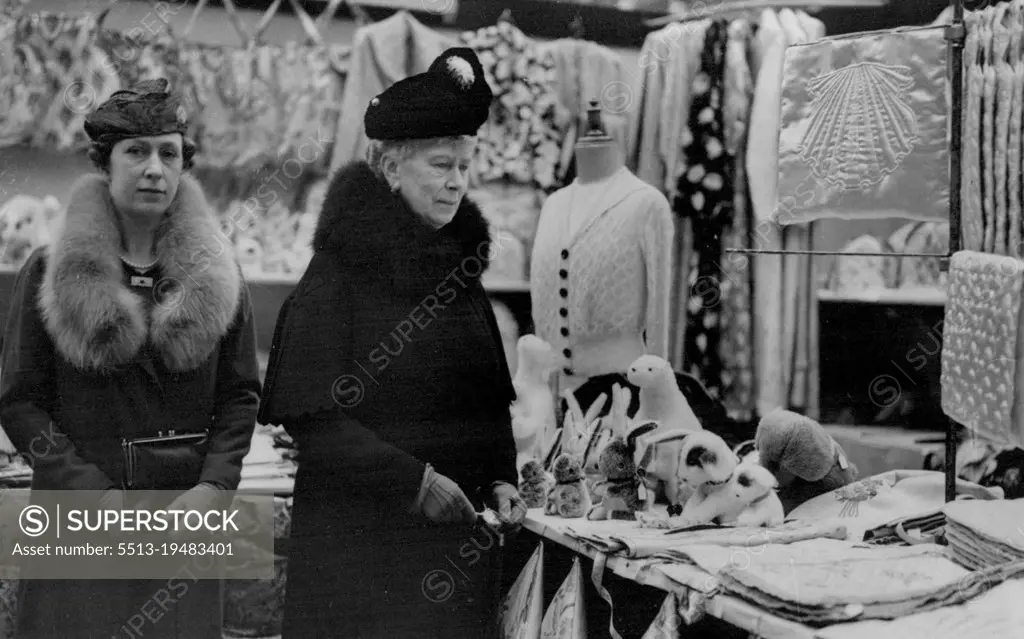 Queen Mary and Princess Royal Visit War-Disabled Men's Exhibition - Queen Mary with The Princess Royal looking at toys at the St. Dunstan's stand. Queen Mary, accompanied by the Princess Royal, this morning paid a visit to the exhibition and Sale of Goods made by War-Disabled men at the imperial institute, Kensington, which is being opened on Friday by the Duchess of Kent. November 03, 1937. (Photo by Keystone).