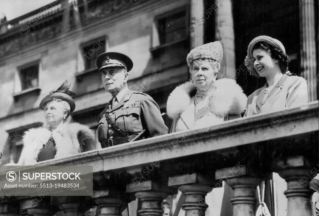 The King Presents New Colours To Welsh Guards - Queen Mary and Princess Elizabeth, with the Earl and Countess of Athlone, watching the ceremony. The King, as Colonel-in-Chief of the ***** Guards, today (Wednesday) presented new colours to the 1st Battalion of the Regiment in the gardens of Buckingham Palace. The Guards were their peacetime uniform, but as there are not enough scarlet tunics to equip the entire battalion, only 200 officers and men took part in the ceremony, the remainder parading as spectators, wearing battle dress. May 25, 1949. (Photo by Reuterphoto).