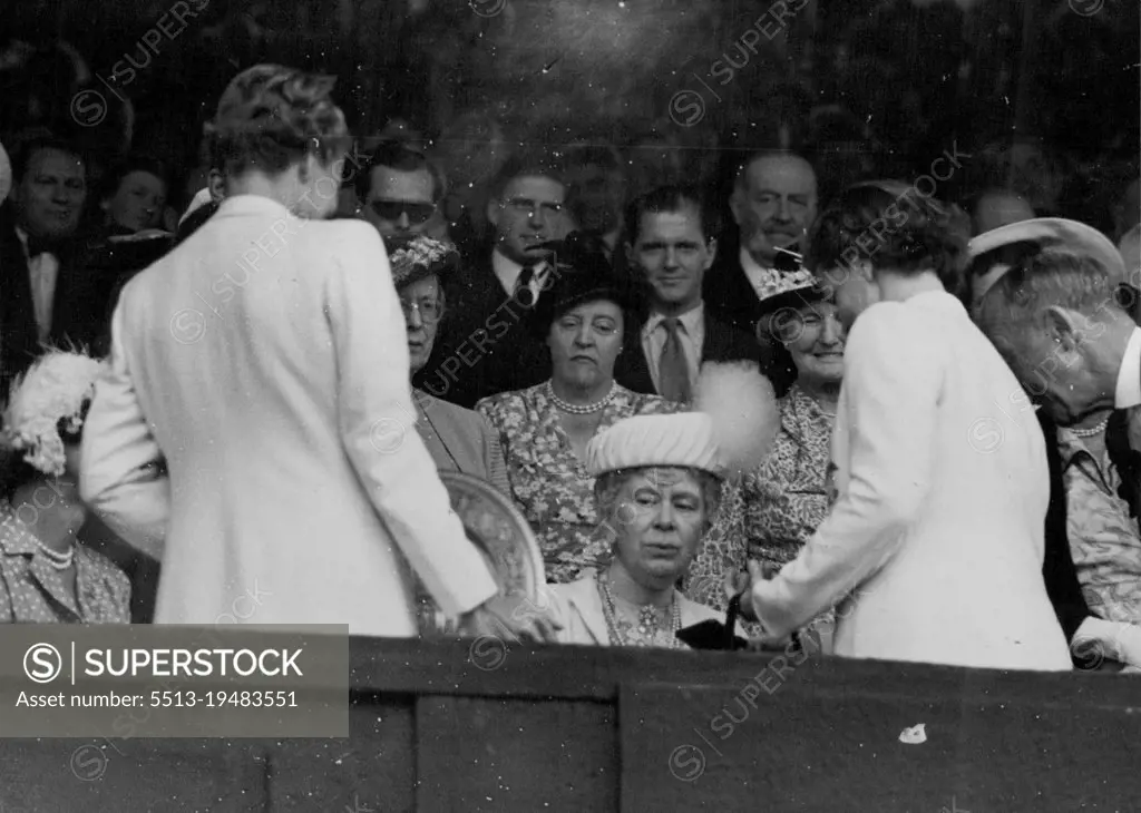 Lawn Tennis Championship Finals At Wimbledon -- H.M. Queen Mary presents the ladies Gold Salver for the singles championship to Miss Louise Brough after her match today against she has won the singles championship. July 08, 1950. (Photo by Paul Popper Ltd.).