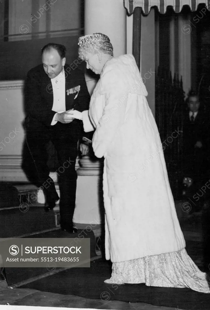 King Carol Acts As Host To British Royalty -- Queen Mary being assisted up the stairs on her arrival at the Roumanian Legation for the dinner on November 16. King Carol of Roumania was the host at the Roumanian Legation, London on November 16, The guests including the king and Queen, Queen Mary, other members of the royal family, and gave them a six course dinner, arranged by Mme. Grigorcea, wife of the Roumanian Minister in London. There were 57 guests in all, seated at a Horseshoe table. November 17, 1938. (Photo by Associated Press Photo).