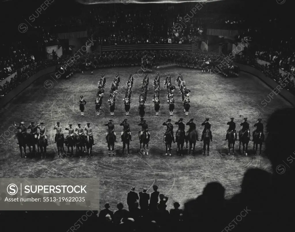 Salute To The Flags... The Five Army Teams -- United States, Canada, France, Irish free state and Chile - lifting their arms in salute to the flags, with the 16th infantry band in the background, thrilling the brilliant gathering that packed the Madison Square Garden, New York,  for the opening night's performance of the National horse show. The officers and picked mounts of the five nations later competed. November 7, 1934. (Photo by Associated Press Photo).