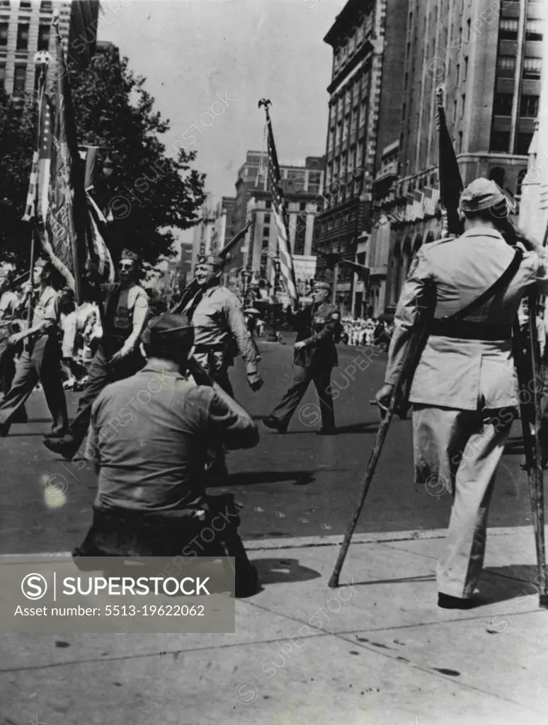 Their Loyalty Unquestioned -- They pay respects to the uniform and to the flag. These two wounded war Veterans couldn't march in the Veterans of Foreign wars convention parade here August 26th, but their loyalty is unquestioned. October 1, 1941. (Photo by ACME).