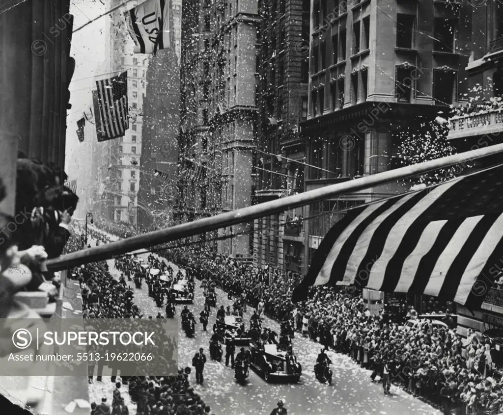 Heroes On Parade -- Flags flying, paper showers swirling, New York City recently gave one of the tumultuous receptions it reserves for something special to 15 English and American war heroes. Commandos and RAF pilots fresh from attacks on the Axis in Europe and Africa, Yank flyers and sailors who dealt death to the Japanese in the Pacific, they were parade up famous Broadway to the cheers of thousands, then were hailed at a monster reception that night at Madison Square Garden.Admirers line the sidewalks ten deep as the fighters ride up Broadway. Flags whip from the tall buildings while ticker tape-- New York's favorite confetti for its heroes -- pours down from the windows by the ton. January 9, 1951. (Photo by Interphoto News Pictures, Inc.).