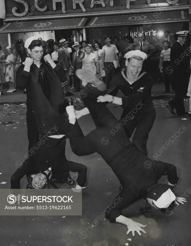 Broadway Capers -- Four sailors contributed these antics for the amusement of the many people awaiting news of the Japanese surrender in New Yorks Times Square, August 14. August 14, 1945. (Photo by Associated Press Photo).