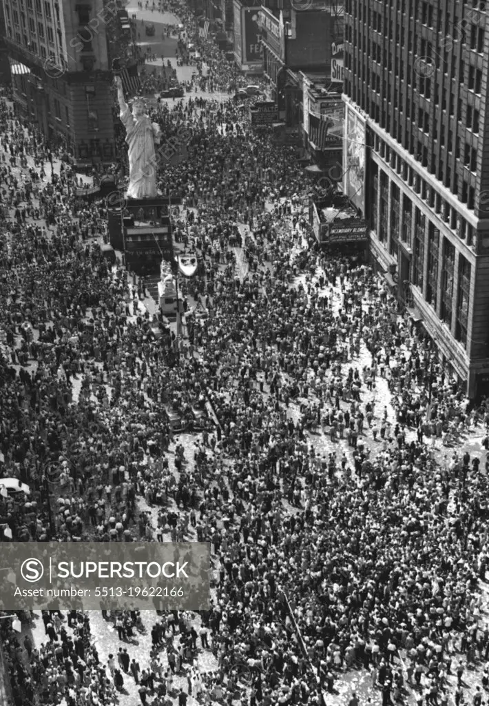 New Yorkers Wait.. And Wait -- An estimated crowd of 150,000 mostly young girls, youths and servicemen, continued to await further news of war or peace developments in Times Square, New York City, on Tuesday afternoon, Aug 14th. This was the scene at the intersection of Broadway and Seventh Ave., looking south from 44th Street, with N.Y. Times Tower in left background and reproduction of Statue of Liberty at left center. August 14, 1945. (Photo by Associated Press Photo).