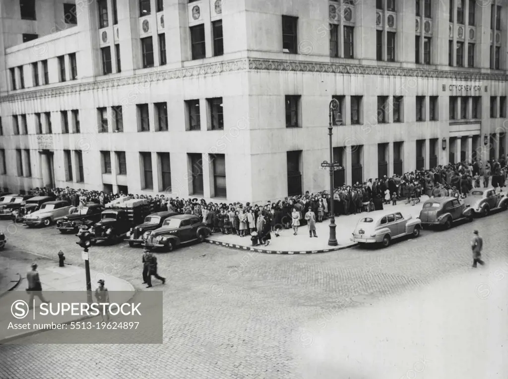 Waiting For Vaccinations -- Crowds line the sidewalk leading to entrance of the Health Department Building, New York City, April 14, as they wait their turn to receive smallpox vaccinations in response to Health Commissioner Israel Veinstein's Radio Plea that the public be vaccinated after nine cases, including two facilities,were reported. April 14, 1947. (Photo by Associated Press Photo).