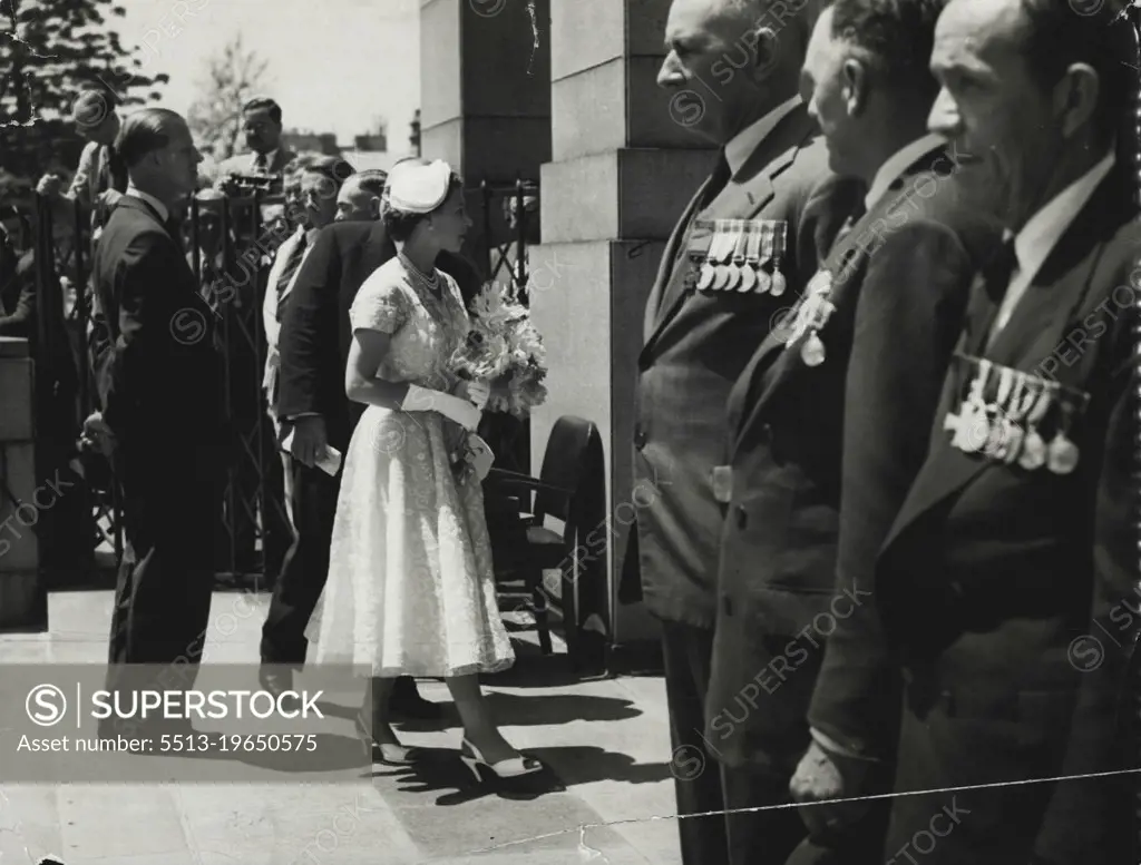 The Queen has a warm glance for three VC holders, standing in their places of honor, as she entered the Anzac Memorial this morning. Pictured are A.C. Hall, Judge Storkey, and Joseph Maxwell. February 5, 1954.