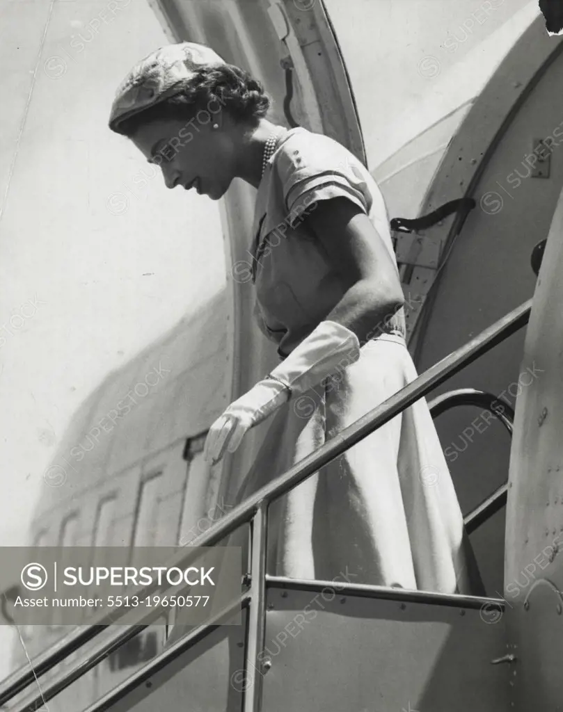 A Striking Profile of the Queen as she alights from her plane at Mascot today. The photographer has caught the Queen as she watches her step on the gangway. February 18, 1954.