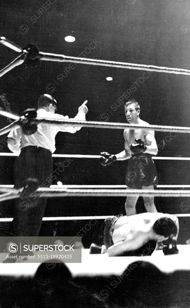 Philips Knocks Out Foord In The Ninth Round -- The ***** of the fight Ben Foord being counted  out while Philips looks on. June 21, 1938.