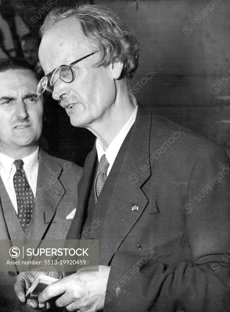 Piccard Explains His Bathyscape -- Spectacles with a hinged second lens ***** a touch of the Bizarre to Professor Auguste Piccard as he is pictured aboard the cargo steamer Scaldis at Antwerp, Belgium, September 10, explaining ***** Bathyscape to scientists and reporters. The Bathyscape is a forty-ton steel ball, construction of which has taken Piccard and his assistant Max Cosyns, two years to perfect. In it they will descend to  unexplored depths of the gulf of Guinea, East Indies. Suspended beneath a huge float, containing Petroleum - "Gasbag" for the Bathyscape - the sphere will be lowered  at first without crew, several miles beneath the surface. September 07, 1955. (Photo by The Associated Press Ltd.).