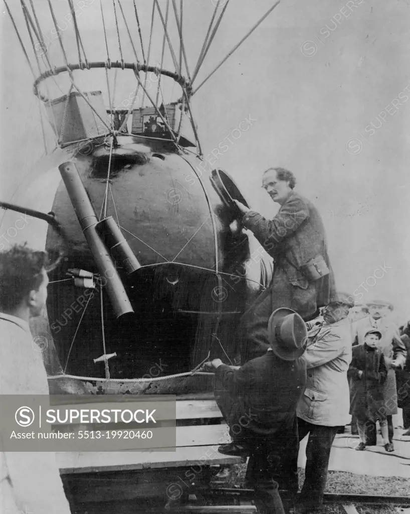 10 Miles Up In A Balloon -- Prof. Auguste Piccard climbing into the aluminium globe attached to the balloon.In a hermetically sealed cylinder hanging from a giant balloon, a Swiss scientist today began an attempt to go higher in the air than man has ever gone before. He is Prof. Auguste Piccard, member of the staff of Brussels University, and he hopes to reach a height of ten miles above the earth. He is accompanied by an assistant. The start was made soon after dawn from a field at Augsburg, Bavaria. May 27, 1931. (Photo by Topical Press).