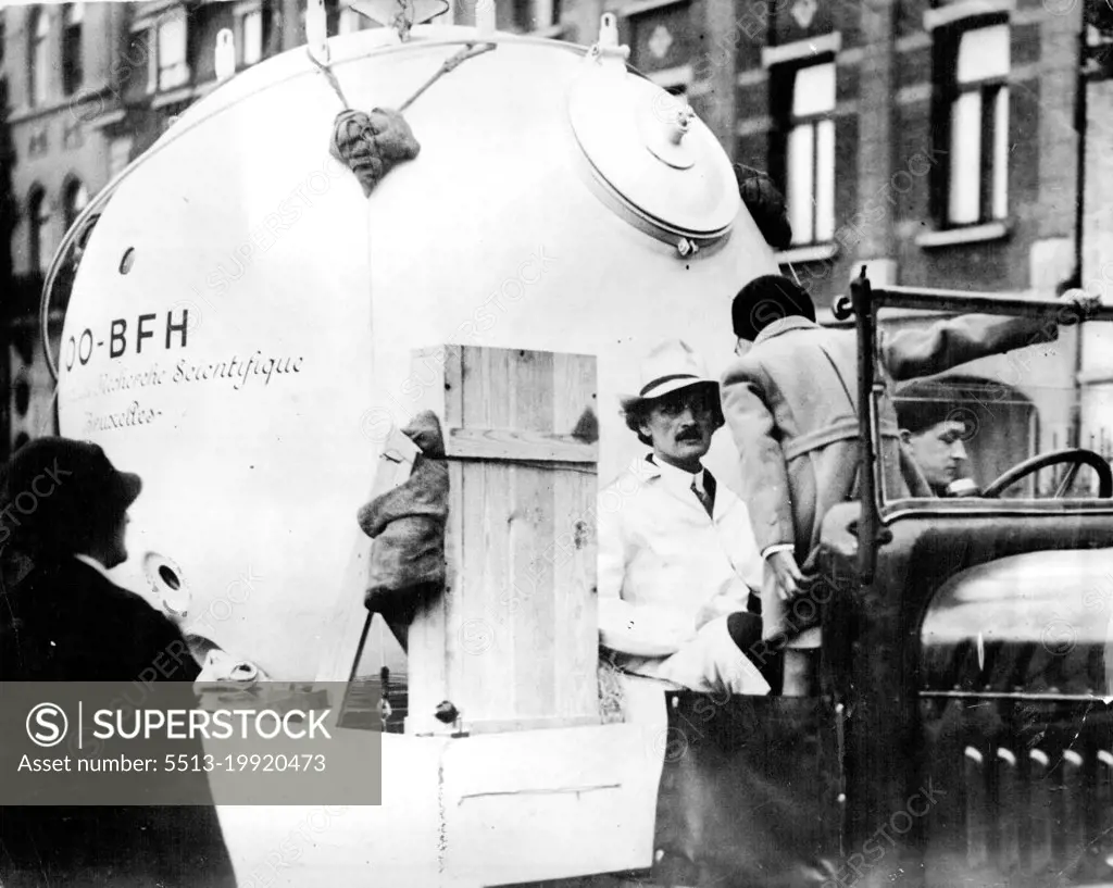 Prof. Piccard Leaves For Zurich Flight Into Stratosphere -- Professor Piccard about to leave Brussels on lorry with his new aluminium sphere in which he will make the flight. Professor Piccard, accompanied by his helper Max Cosyns and M. Kipper, left Brussels yesterday August 1 for Zurich where he will ascend into the stratosphere as soon as weather conditions permit. The Professor is not aiming to beat his previous record but to study the cosmic rays. He will take with him a short-wave transmitting wireless set. September 26, 1932. (Photo by The Associated Press of Great Britain Ltd.).