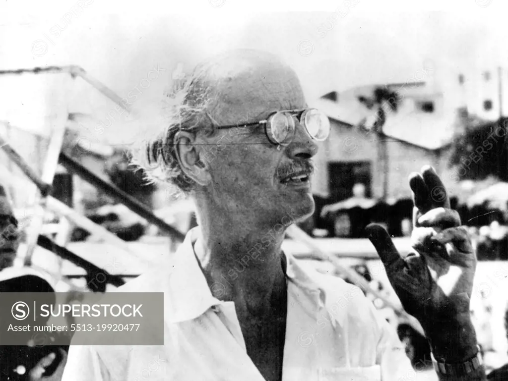 Piccard Leaving On World's Greatest Deep Sea Diving Expedition -- Professor Auguste Piccard is surrounded by reporters aboard the 4,000-ton steamer "Scaldis" just before his departure with his friend and colleague, Professor Max Cosyns, for the Gulf of Guinea, off the West coast of West Africa, with their bathyscaphe, for the greatest deep-sea diving expedition of modern times.when they expect to descend 2½ miles into the depths of the ocean for observations, and expected possible new discoveries inside their steel globe on the hither to unexplored ocean bed. October 8, 1948.