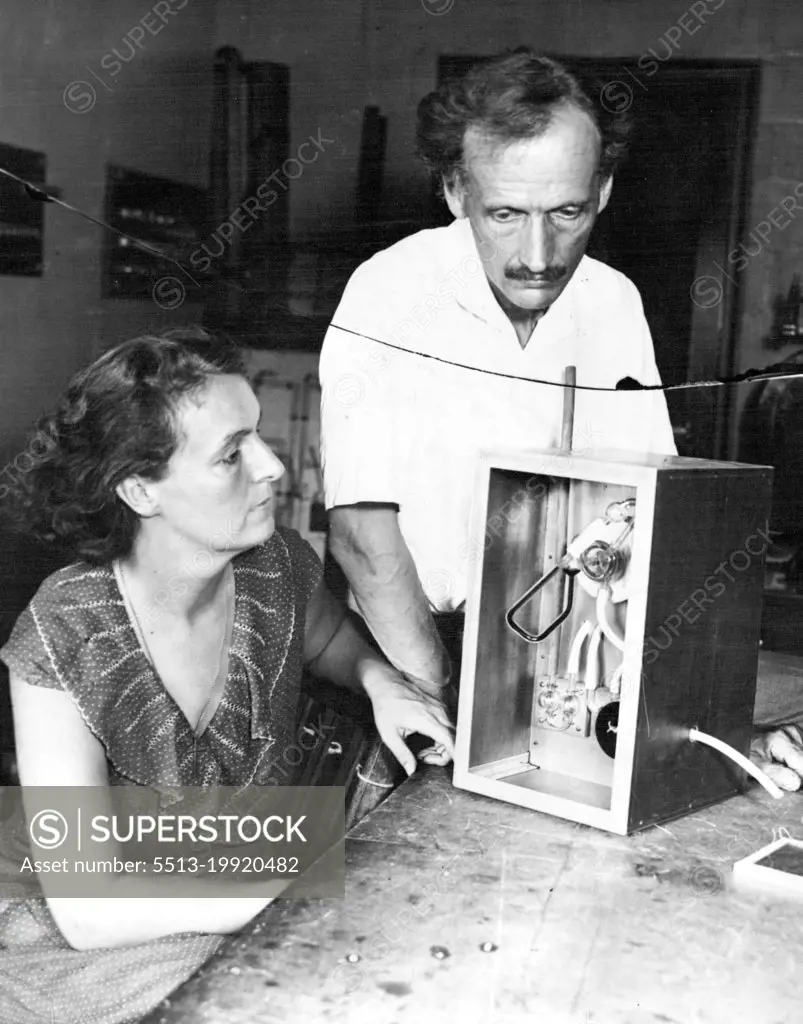 Piccards prepare for another stratosphere flight: Mr. and Mrs. Piccard with Barometer they will use to tel the height of their proposed flight. Mr. and Mrs. Jean Piccard are making final preparations for their planned forthcoming stratosphere flight. July 31, 1934. (Photo by Wide World Photos)