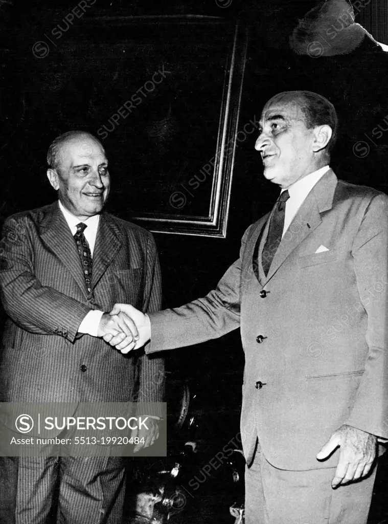 Italian Politicians: Attilio Piccioni -- Attilio Piccioni, second in command of the Italian Christian Democrat Party, was invited by the President of Italy to form a new Cabinet, but failed. Our photograph shows Senor Piccioni (left) shaking hands with Giovanni Gronchi, President of the Chamber. August 21, 1953. (Photo by Camera Press).