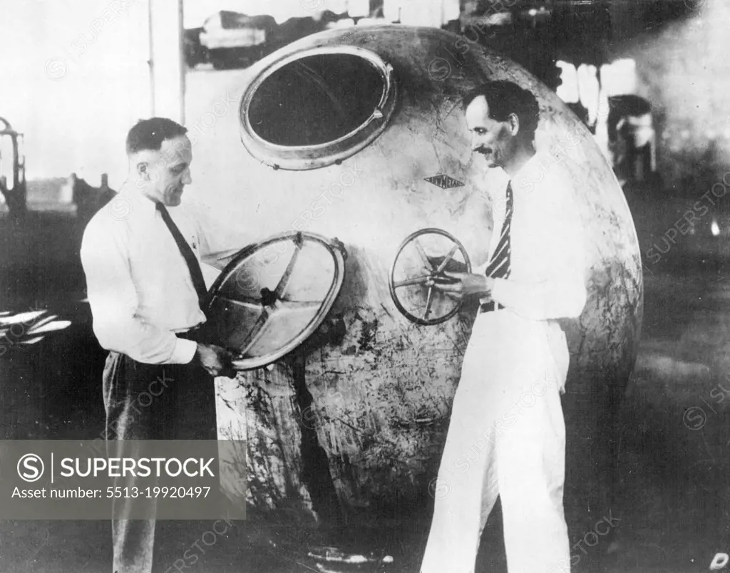 Professor Jean Piccard And Commander Settle Make Stratosphere Ascent -- Professor Jean Piccard (right) and Lieut. Commander T.G.W. Settle inspecting their gondola.Professor Jean Piccard and Lieut. Commander T.G.W. Settle of the United States Navy were scheduled to make their journey into the stratosphere. Professor Piccard is a twin brother of Professor Auguste Piccard who ascended to a height of ten miles last year. This time it is hoped to reach a height of 17 miles over Chicago in a special gondola. July 19, 1933.