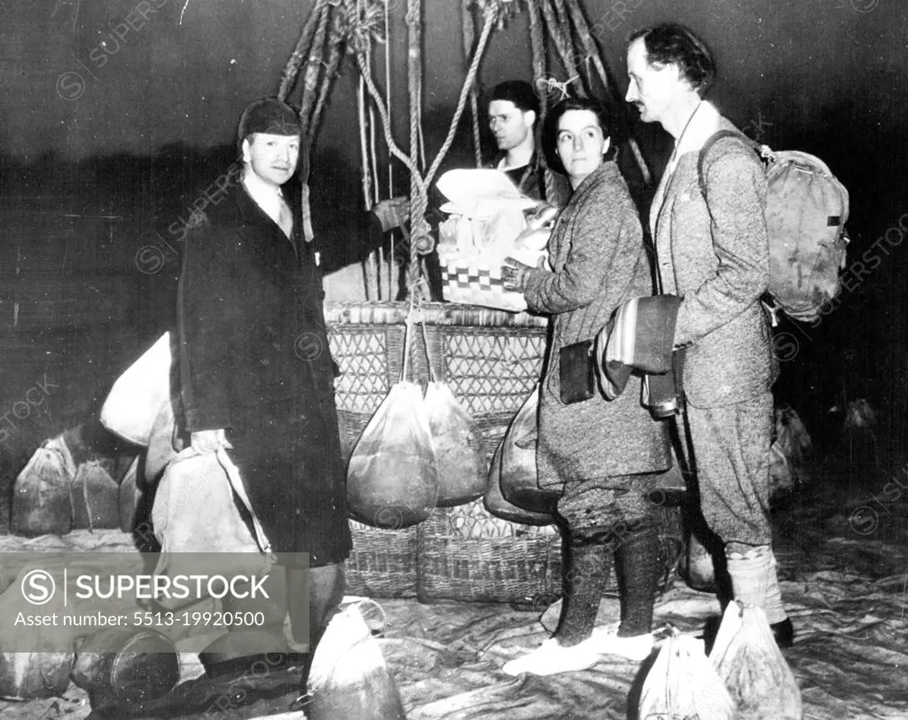 Mrs. Piccard Trains For Stratosphere Flight -- Mrs. Jeannette Piccard, who is training for a flight into the stratosphere with her husband, Professor Jean Piccard, is shown with her husband, at right, and Edward J. Hill (left), well known balloonist, just before they took off on a training flight at Detroit, May 16. Her balloon, which left at Daylight, was forced down on a farm near Thomasville, Ont., later in the day by high winds. May 16, 1934. (Photo by Associated Press Photo).