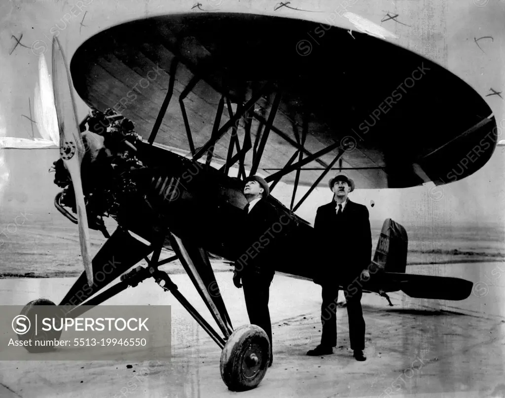 Two spectators studying the quaint round wings of the machine before the trial flight.The "Umbrella Plane" It has only wing, is designed to travel at 135 M.P.H, and can almost land in the backyard, say the inventors, two Chicago men. May 07, 1934. (Photo by Associated Press Photo).