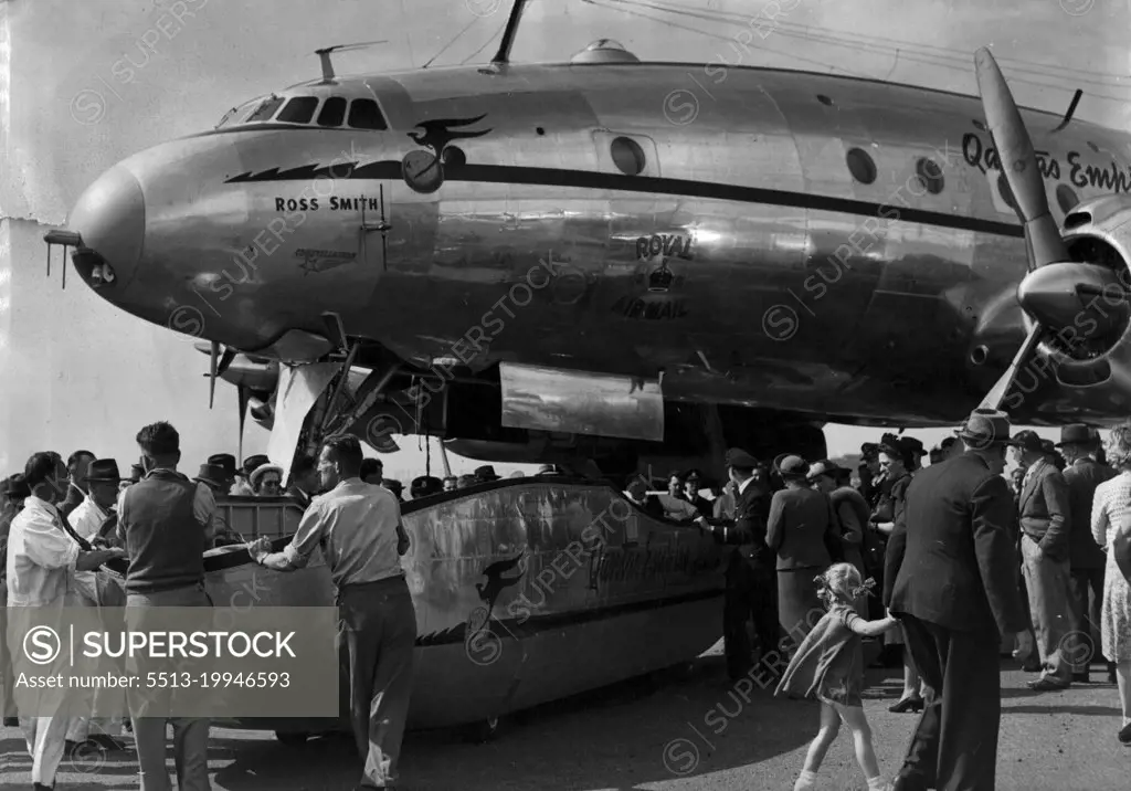 The Speed Pak being wheeled away from the plane. This new luggage carrying device was seen for the first time when the new Cams Lockheed Constellation arrived at Mascot today. It is the first of 4 of this type of aircraft to arrive in Sydney for Qantas. October 14, 1947. (Photo by Ernest Charles Bowen/Fairfax Media).