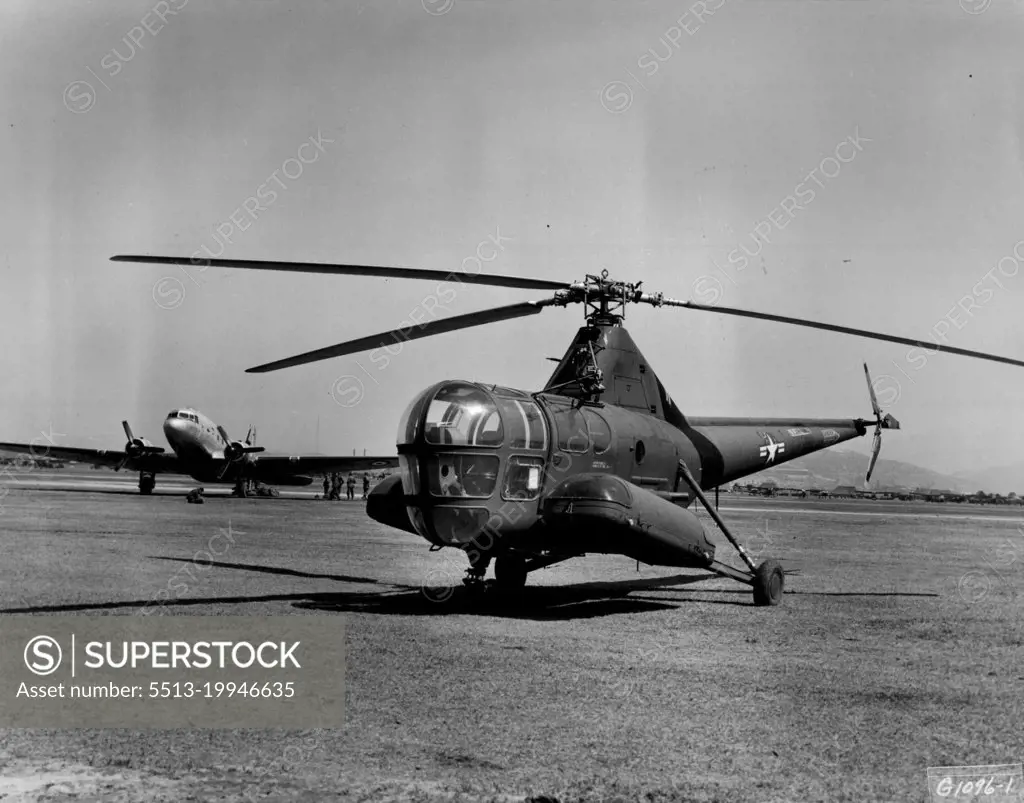 Static--And Active -- A tiny H-5 helicopter of the 3rd Air rescue Squadron sits silently at the ready, while a Far East Air forces C-47 Skytrain of the 315th Air Division (Combat Cargo) is loaded with troops bound for Japan for a well earned rest and recuperation leave. May 8, 1951. (Photo by U.S. Air Force Photo).