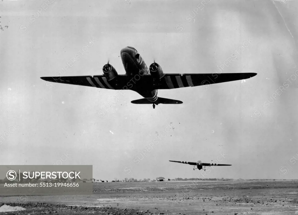 A Ninth Air Force Troop Carrier Command Station -- A C-47 transport is shown pulling a British-built "Horsa" type glider loaded with Yank air bone infantry, into the air in the early morning of 6th. June as the Ninth Air Force Troop Carrier Command sends reinforcements to the Para-trooper dropped behind Nazi line in France earlier the same day. September 4, 1944. (Photo by U.S. Official Photograph).