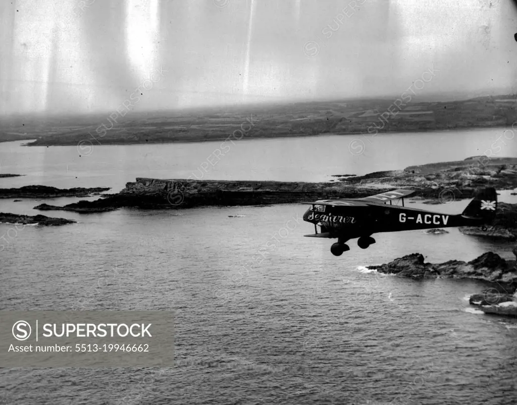 The Mollison Flight. - Air Views as "Seafarer" crosses Ireland -- "The Seafarer" skirting the Irish Coast for the Transatlantic Flight.A series of Aerial views taken from an accompanying aeroplane, showing "Seafarer" with Mr. And Mrs. J.A. Mollison abroad, passing the Irish coast en route for America, over The Atlantic. They succeeded in the crossing but unfortunately crashed at Bridgeport, Connecticut. Both are now in Hospital. September 5, 1933. (Photo by The Associated Press of Great Britain Ltd.)