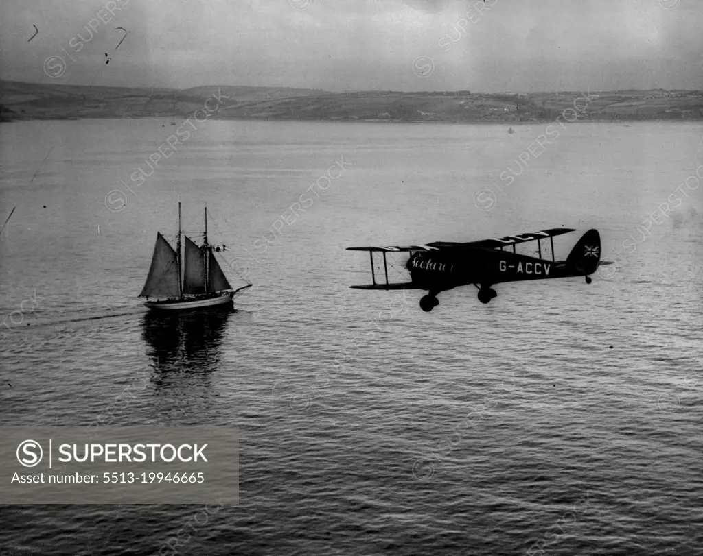 The Mollison Flight - Air Views as "Seafaber" Crosses Ireland. - "The Seafarer" passing a Schooner off Cork Harbour.A series of Aerial views taken from an accompanying aeroplane, showing "Seafarer" with Mr. and Mrs. J.A. Mollison abroad, passing the Irish coast en route for a America, over the Atlantic. They succeeded in the crossing but unfortunately crashed at Bridgeport Connecticut. Both are now in Hospital. July 25, 1933. (Photo by Associated Press Photo).