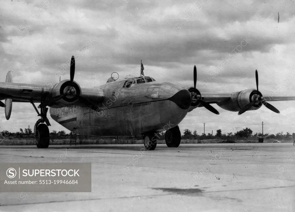 Liberator Aircraft On Tarmac At Guildford Aerodrome - Hull, polished aluminium propellers black or deep blue with yellow tips. Nose and line running aft, navy blue. Speed bird and "Qantas Empire Airways", red. Kangaroo, red.Stripes aft, Navy Blue and white. Ensign, light blue ground with navy blue and white cross. Tyres: dark grey. February 26, 1949. (Photo by Qantas Empire Airways Ltd.).