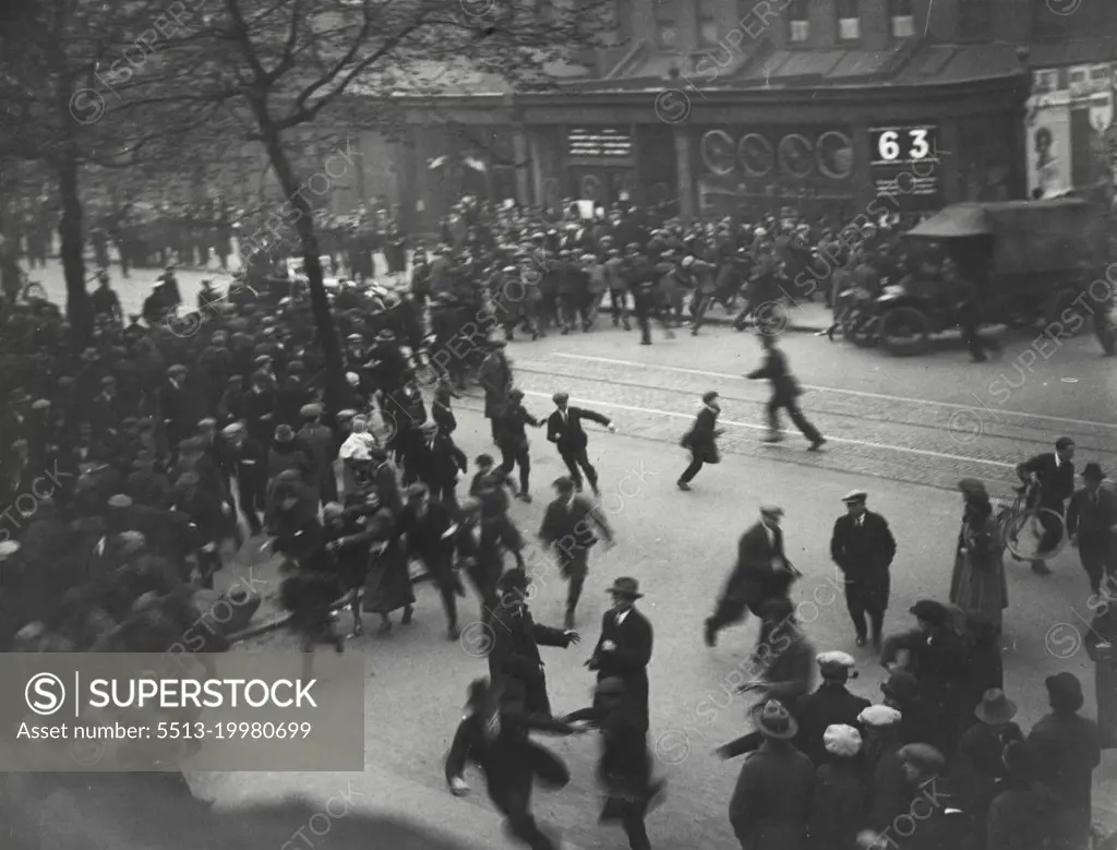 The General Strikes -- The crowd running as a police car arrives. Police are seen with drawn batons. A snap in New Kent Road on Thursday night.January 26, 1936. (Photo by London News And Agency Photos Ltd.).