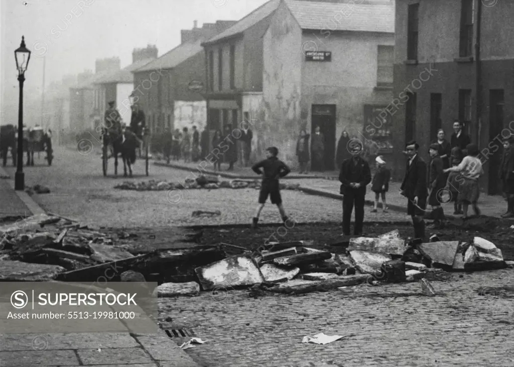 The Riots in Belfast -- ***** street, Falls Road, one of the many thoroughfares in this ***** where the roads were torn up to obstruct the armoured *****. November 21, 1932. (Photo by Central News).