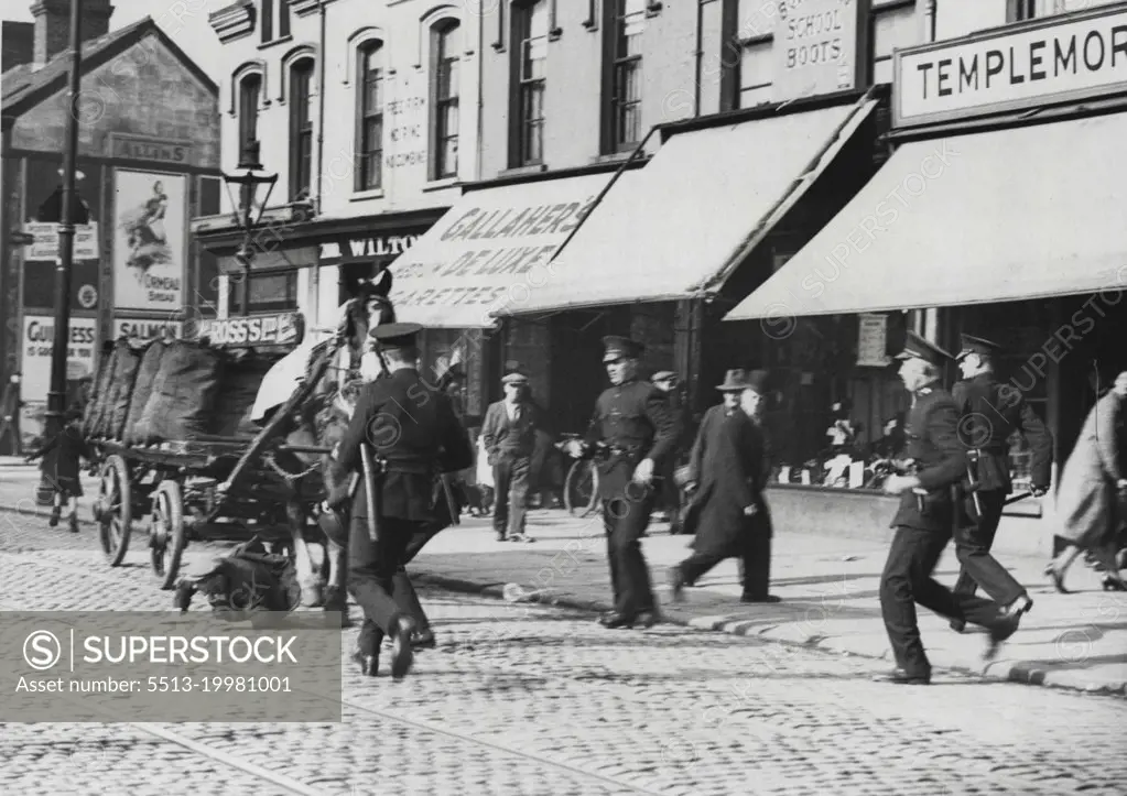 The Riots in Belfast -- After the melee at Templemore Avenue. The police capturing one of the offenders who fell during the chase. November 21, 1932. (Photo by Central News).