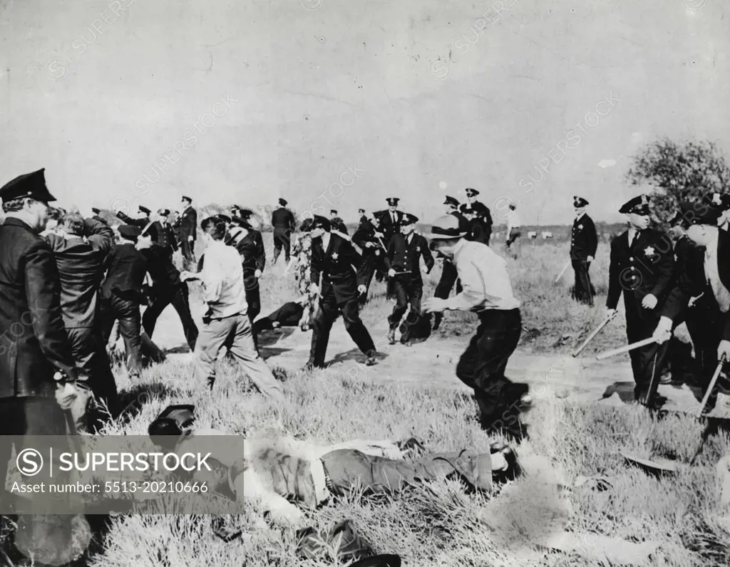 4 Killed, 83 Hurt, As Steel Strikers Battle Chicago Police -- Scene in front of the Republic Steel Company here as police put to route 1,000 C.I.O. strikers marching on the company's South Chicago Plant May 30. Note the two men in the foreground who were felled. The man wearing a white shirt and a grey hat went down just after this picture was taken. A policeman in the center background is yanking out his revolver. May 31, 1937. (Photo by Wide World Photos).