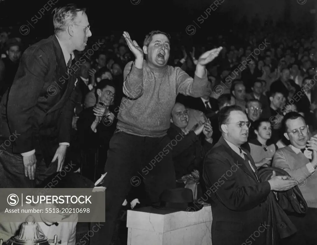 Striker Shouts Against Settlement - A worker of the Philadelphia Transportation company shouts against settling the transit strike here early today during a mass meeting of strikers after negotiators had reached agreement in the ten-day strike. Other strikers applaud or shout during the stormy session. February 20, 1949. (Photo by AP Wirephoto).