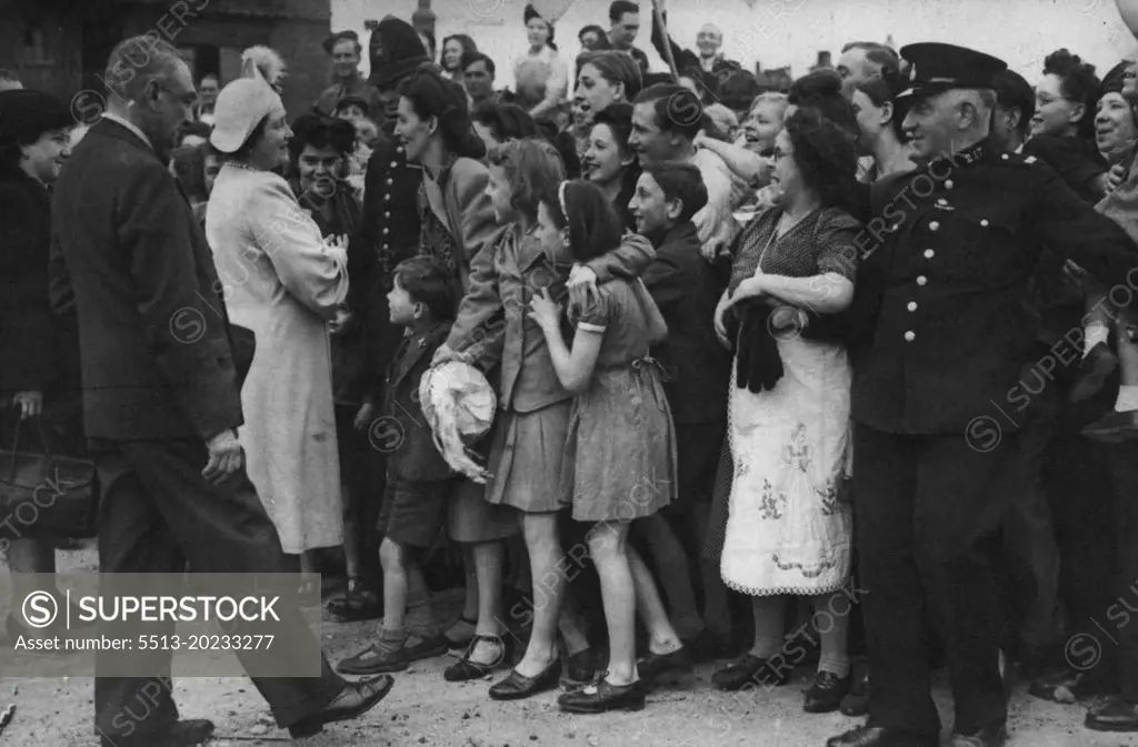 Royal Family Tour The East of London During Ve Day Celebrations -- A London Mother and her family talk with her majesty the Queen, during her Ve Day Tour of East London.For over two hours the Royal Family toured the East End of London, talking with men and women who were enjoying their Victory celebrations, yesterday May 9. The jubilant crowds gave they a tremendous reception, waving flags and throwing red white and blue streamers across the Royal car. May 10, 1945. (Photo by Associated Press Photo).