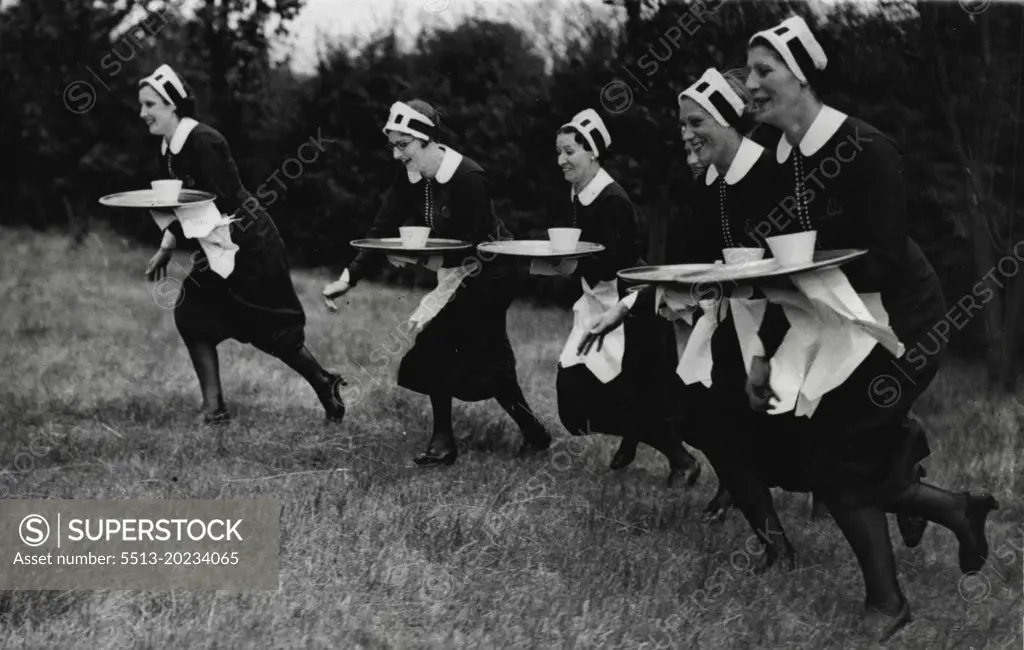 Sports Carnival At Sudbury.Waitresses carrying plays during the "Nippies" race. August 30, 1937. (Photo by Keystone).