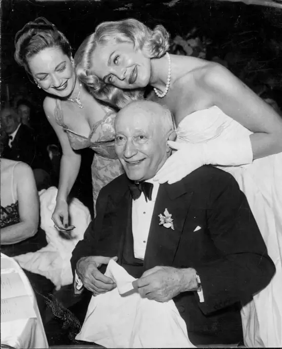 Dorothy Lamour and Lizabeth Scott join in congratulating Zukor at his 80th birthday party at the Waldorf-Astoria, New York, on March 4, 1953. March 20, 1953.