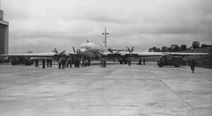 The Brabazon's 'Props' Turn -- The engines of the 'Brabazon' being 'tuned-up' outside its hangar at Filton, Bristol. Shortly after half-past seven this (Saturday) morning, the 'Brabazon', largest civil landplane in the world, was on its mile-and-a-half long runway at Filton, Bristol. ready to start taxi-in tests. It left its hangar yesterday for a final check-up, technicians using mobile scaffolding to inspect the wingh, rudder and the eight 2,500 h.p. engines. After its tests today the 130-ton