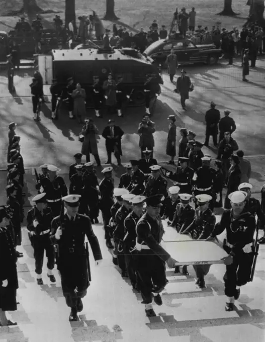 U.S. Constitution Moved To National Archives -- A military escort carries the Constitution of the United States into the National Archives building here today after its transfer from the Library of Congress. In background is the armored car in which the priceless documents were transported under military guard. The documents are encased in six helium-filled cases and will be permanently housed in what is believed to be the World's largest safe. December 13, 1952. (Photo by AP Wirephoto).