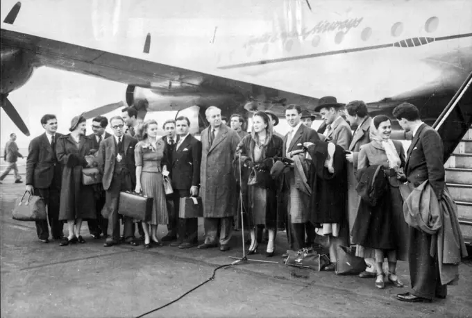 Shakespeareans Go By Air 14 Weeks Tour Of Australia -- Members of the Shakespearian Memorial Company as they left London Airport, At the microphone is Miss Diana Wynyard, the actress. On left of Miss Wynyard is Colonel Fordham Flower, chairman of the Board of Governors of the Company. Members of the Shakespearian Memorial Theater Company of Stratford-on-Avon, led by Diana Wynyard and Anthony Quayle, the director, left London Airport by B. O. A. C. -Qantas aircraft for a fourteen weeks tour of Au