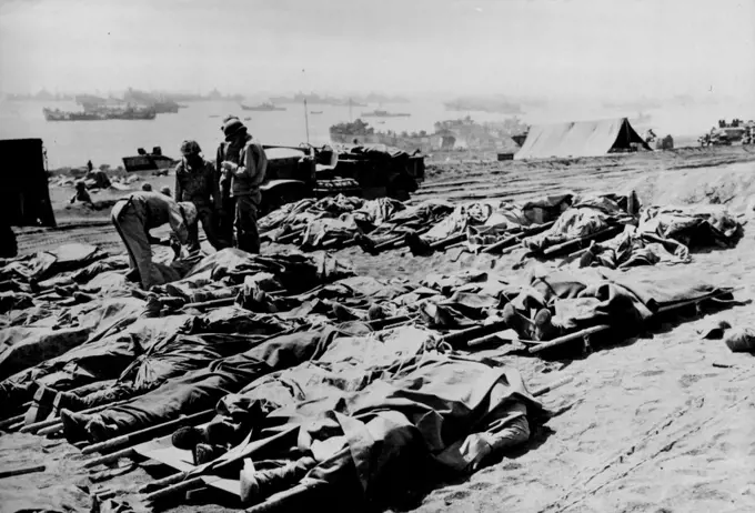 Dead U.S. Marines Lie On Iwo Jima Beach -- U.S. Marines killed when American forces landed Feb. 18, 1945 lie on the beach of Iwo Island, Japanese military outpost 750 miles (1,200 km.) from Tokyo, capital of Japan, More than 2,050 U.S. Marines and more than 12,800 Japanese were killed in the first three weeks' of bitter fighting on the volcanic island, as Japanese troops were pushed to the northernmost tip. April 4, 1945. (Photo by U.S. Office of War Information Picture).