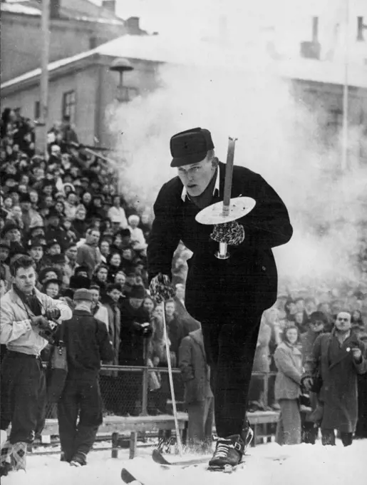 Opening Of The Winter Olympics -- A skier carrying the Olympic Torch arrives at the stadium at Oslo for the opening ceremony at the start of the Winter Olympic Games. February 18, 1952.