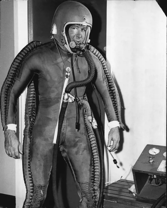 Test Pilot Bill Scott, in inflated pressure suit, only one in Australia, used for testing high altitude flying in our new jet machines. March 9, 1955. (Photo by Gordon F. De'lisle).