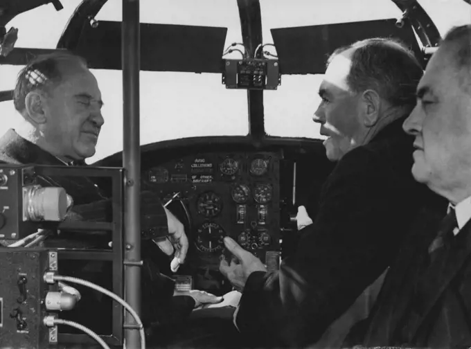 Premier Mc. Kell & Police Commissioner Mackary sit at the controls of the Police arrs at Mascot today. July 22, 1946. (Photo by Bob (Robert) Rice/Fairfax Media).