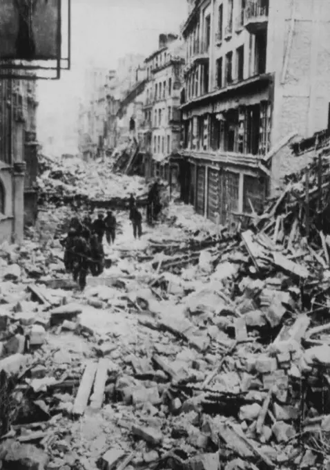 Allies Push Through Caen -- Continuing the drive which wrested the city of Caen from enemy hands, Allied troops pour through the Normandy coast community in pursuit of withdrawing German forces, giving them no opportunity to regroup. These troops are en route to the front. July 11, 1944. (Photo by Associated Press Radiophoto).