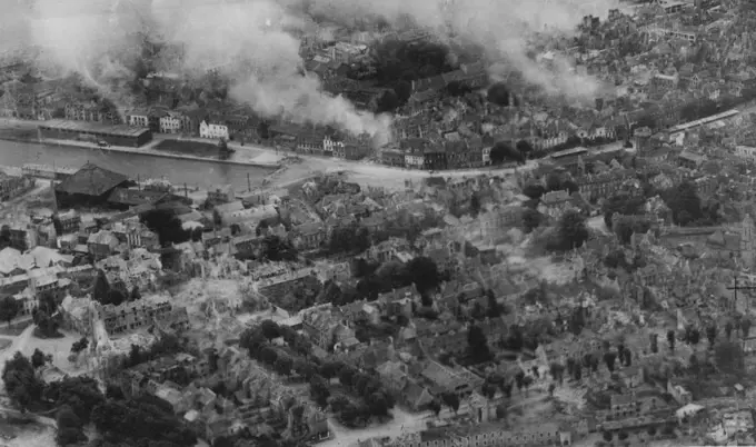 The Capture Of Caen -- The town of Caen was captured today, July 9th, after the offensive opened by British and Canadian troops of general Dempsey's Second Army at Dawn on July 8th. This R.A.F. reconnaissance picture, which was taken in the first week of the Normandy campaign shows fires burning in the town. July 01, 1944. (Photo by British Official Photo).